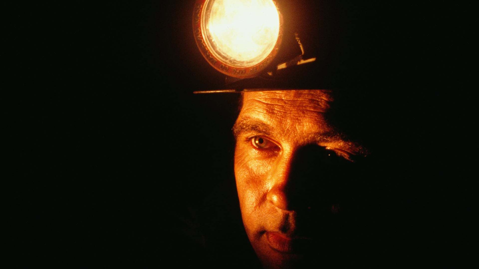 man with light on head